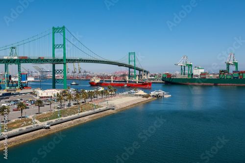 Vincent Thomas Bridge and Container Ships Unloading in Los Angeles California Shipping Port