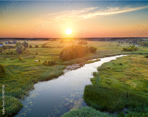 Sunrise in the countryside. River in a meadow. View from above