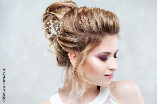 Wedding style. Beautiful young bride with luxury wedding hairstyle