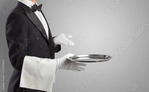 Waiter serving with white gloves and steel tray in an empty space 