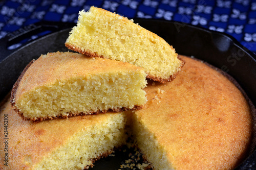 Homemade buttermilk cornbread served in a cast iron frying pan: close up, profile, selective focus.