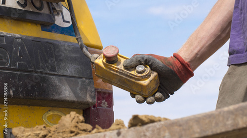 Geotechnical investigation - a hand holding a crane control button