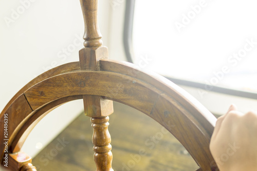 A small motor ship. Steering wheel from retro wood. Shallow depth of field
