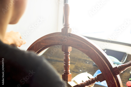 A small motor ship. Steering wheel from retro wood. Shallow depth of field