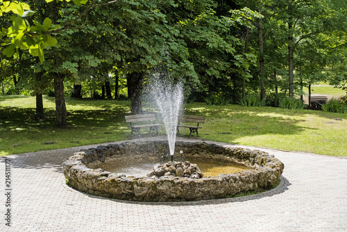 Round fountain in the middle of park.