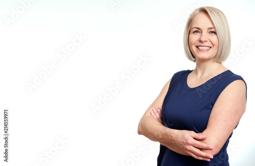 Attractive middle aged woman with folded arms on white background