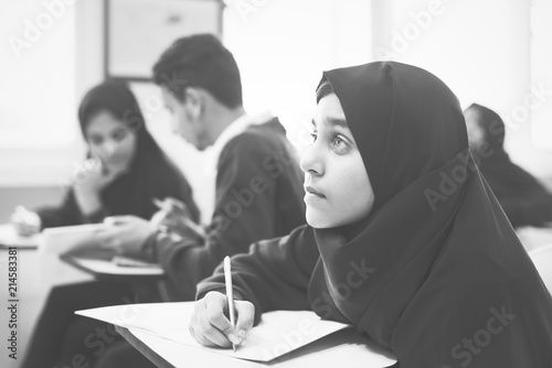 Diverse muslim children studying in a classroom