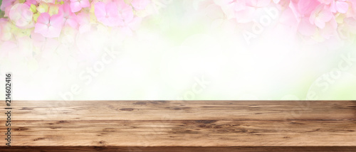 Tender pink flowers with wooden table