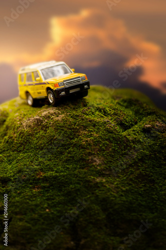 Four by four off road car crossing through the mountain covered with green moss. Travel and racing concept for four wheel drive off road vehicle .