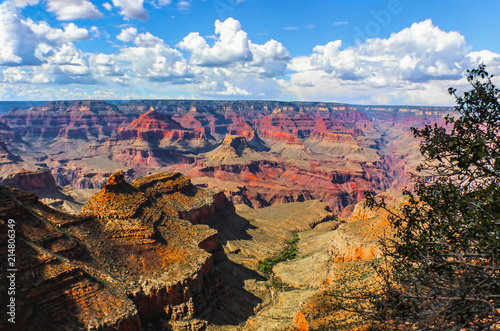 The vastness of the Grand Canyon - View from South Rim at the worlds held in this one majestic canyon with its mesa and rivers and bluffs and cliffs under a dramatic sky