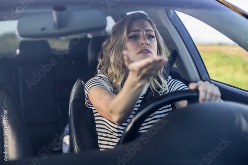 Angry woman driving a car.