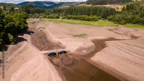 Aerial drone view of a dried up reservoir during a drought in the UK (Llwyn-On Reservoir)