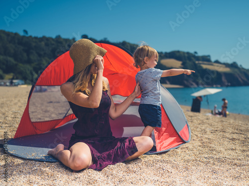 Mother with toddler in beach shelter
