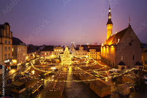 Panoramic view of decorated and illuminated Christmas tree and Christmas Market at Town Hall Square or Raekoja plats, Tallinn, Estonia. Aerial view