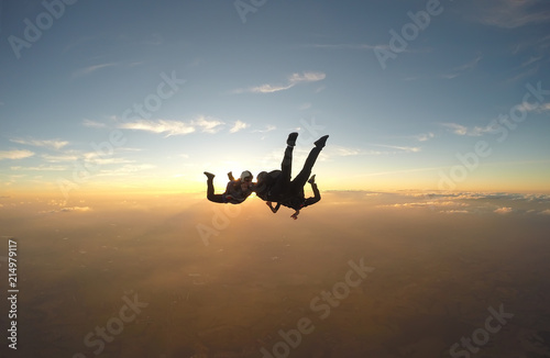 Skydivers having fun at the amazing sunset