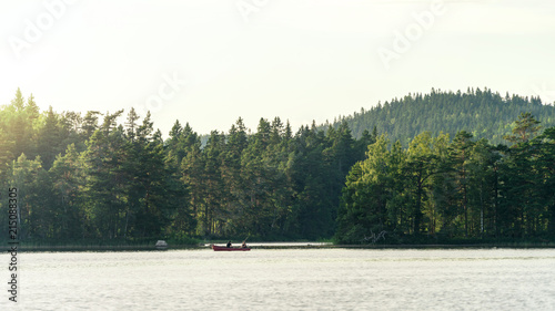 Two people in a boat going fishing, lake in Sweden