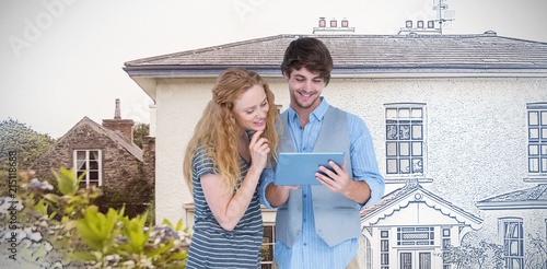 Composite image of happy couple holding tablet computer 