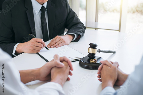 Agreement prepared by lawyer signing decree of divorce (dissolution or cancellation) of marriage, husband and wife during divorce process with male lawyer or counselor and signing of divorce contract