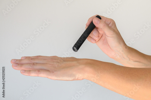 Person holding small device over hand held flat