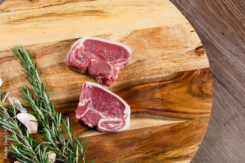 Raw lamb loin slices on chopping board
