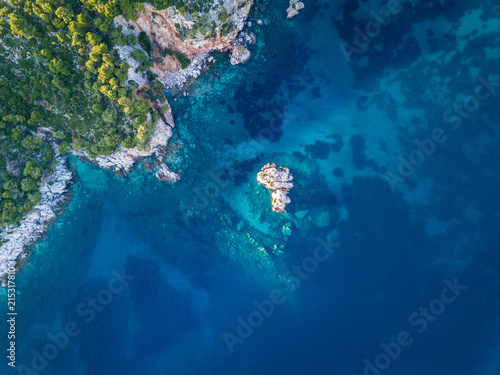Stafilos beach on the island of Skopelos. Offshore viewing the coastline with beautiful aqua water and coral reef from the air.