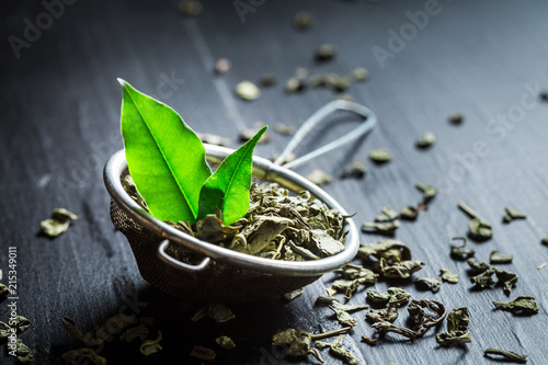 Delicious and fresh green tea in old metal strainer