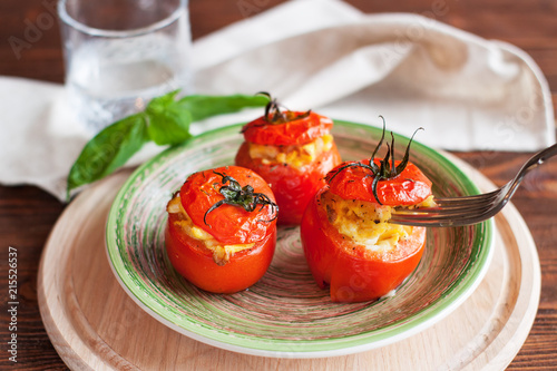 Baked tomatoes stuffed with scrambled eggs