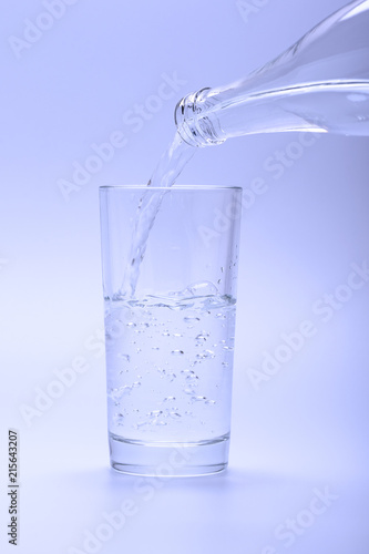 Cold fresh water pouring into glass from a bottle