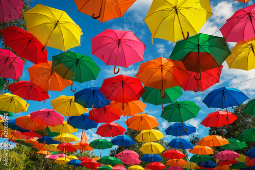 Lots of colorful umbrellas in the sky. City decoration