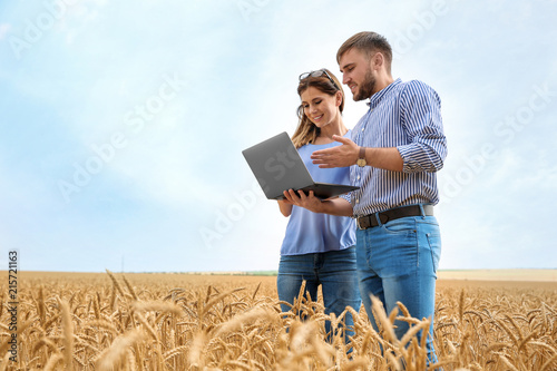 Young agronomists in grain field. Cereal farming