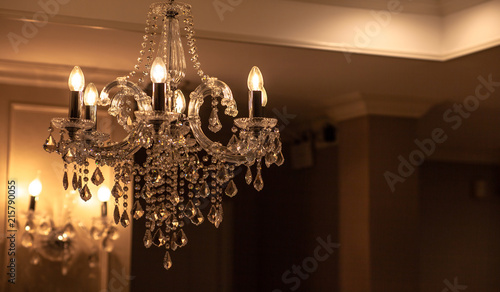 Chrystal chandelier lamp on the ceiling in Dining room Adjusting the image in a Luxury tone .Decorative elegant vintage and Contemporary interior Concept.