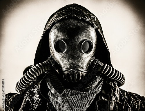 Close up portrait of nuclear post-apocalypse survivor, living underground mutant or creature, skilled stalker wearing rags and armored full-face gas mask or air breathing apparatus, toned shoot