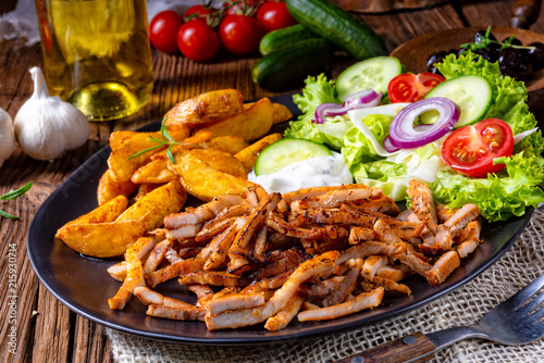 Rustic gyros plate it green salad and potato wedges