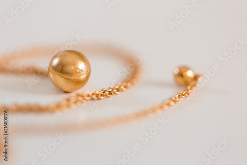 18K golden ball necklace isolated on white closeup