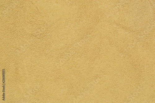 Yellow brownish plaster on wall as background