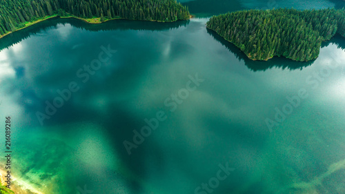 Aerial view of blue lake and green forests on a sunny summer day in Black Lake, Montenegro