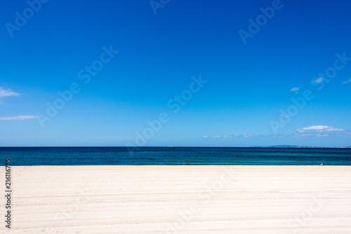 Abandoned white beach with sea at horizon as background