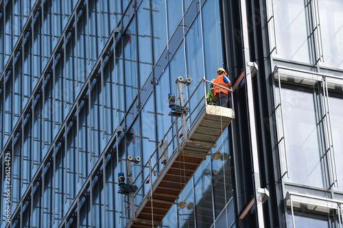 Construction workers on a suspended platform on a skyscraper