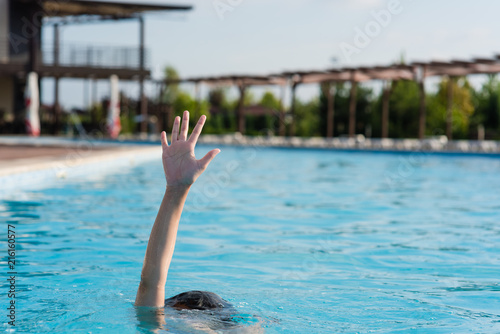Hand up in swimming pool