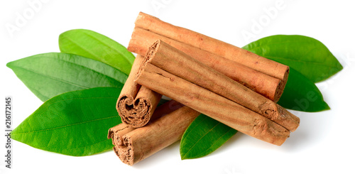 cinnamon sticks with fresh leaves isolated on the white background
