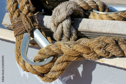 Closeup of two nautical ropes connected together: one with simple eye splice and one with eye splice with thimble