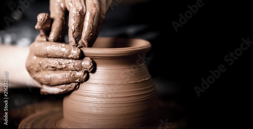 Hands of potter making clay pot