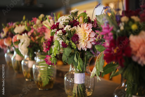 Bride and Bridesmaid's Floral Bouquets in Vases on a Bar - Pink, White, Green, and Purple Wedding Flower Arrangements