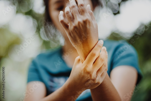 Close up young woman Left wrist pain , office syndrome , health care concept