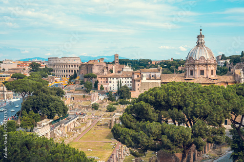 Aerial scenic view of Colosseum, Roman Forum in Rome and church of Santi Luca e Martina, Italy