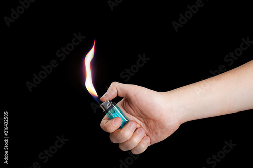 Hand burning a lighter on black background