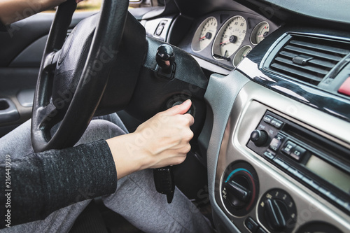 The girl starts the car, inserting the ignition key.