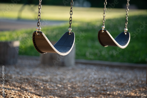 Empty swings on the children's playground