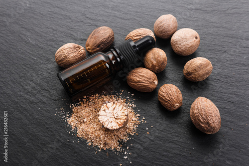 nutmeg essential oil on a dark stone background