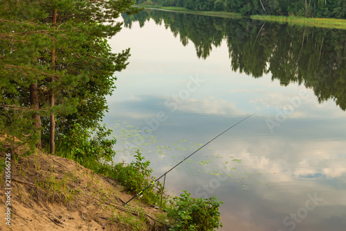 Fishing rod on the river bank. Russian nature. Kostroma region.